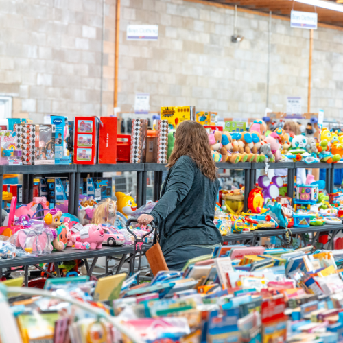 Woman shopping in the toy section of the sale.